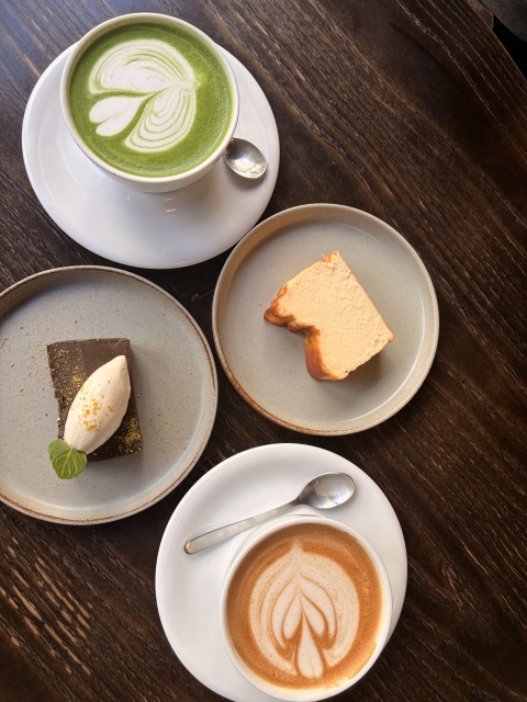 Cup of coffee and pastry on a wooden café table in Japan