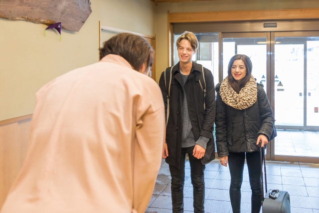 Arriving in Japan: From Airport to Hotel Hotel guests checking in at reception in Japan