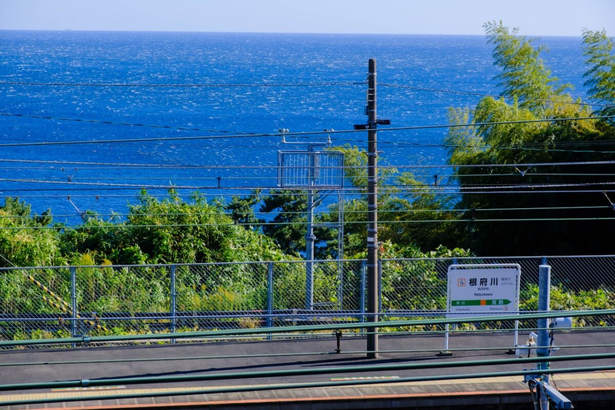 Will English Get You By in Japan? Where It Works — and Where a Little Japanese Helps A view of the ocean from a Japanese train station