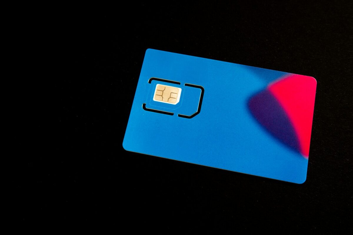 A blue SIM card on a dark surface