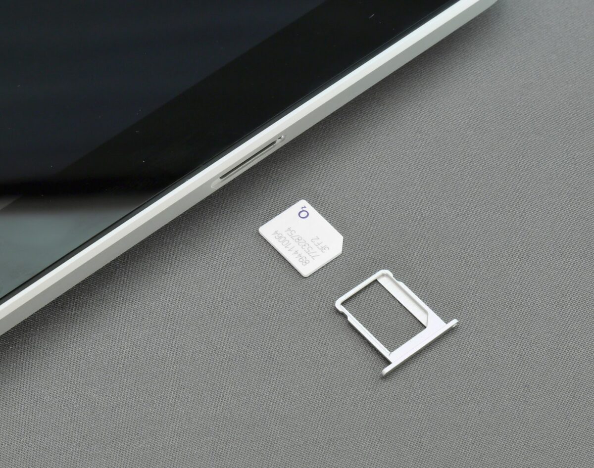 A SIM card beside a smartphone