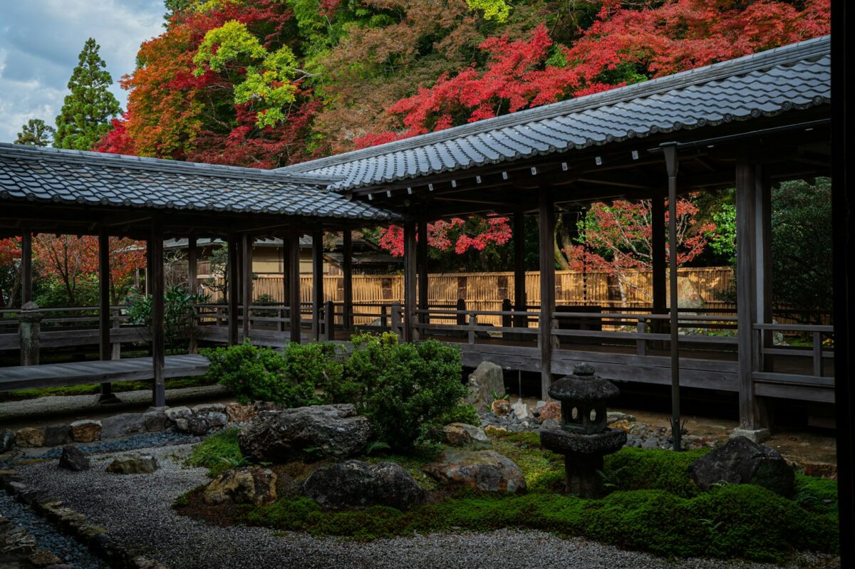 Cultural Etiquette in Japan: Everyday Rules UK Visitors Often Miss A temple corridor beside an autumn garden with a stone lantern