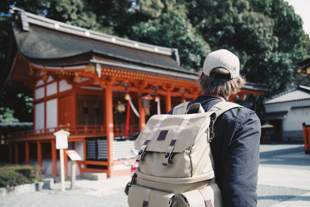 Cultural Etiquette in Japan: Everyday Rules UK Visitors Often Miss A visitor standing near an orange torii gate in Japan