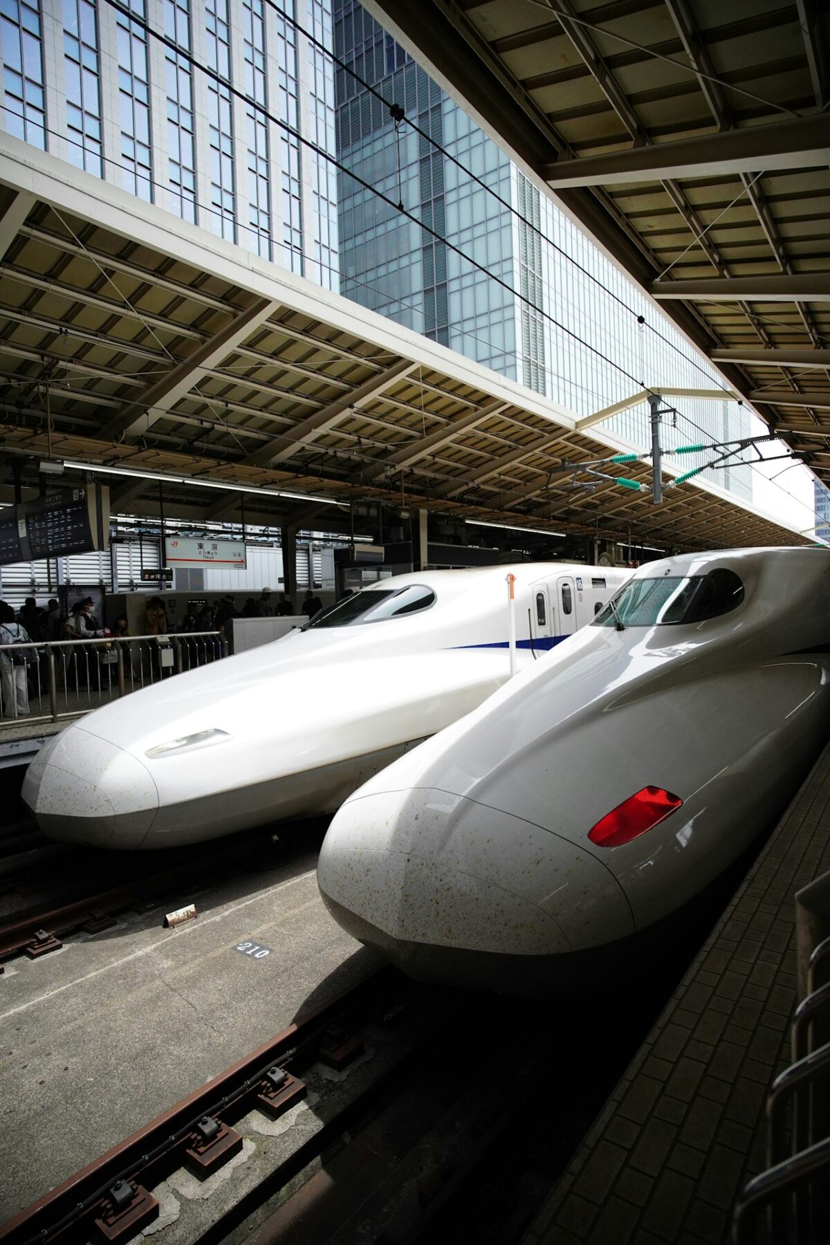 Getting Around Japan: A First-Timer's Guide to Trains, IC Cards and City Transport Two sleek Japanese bullet trains at a station