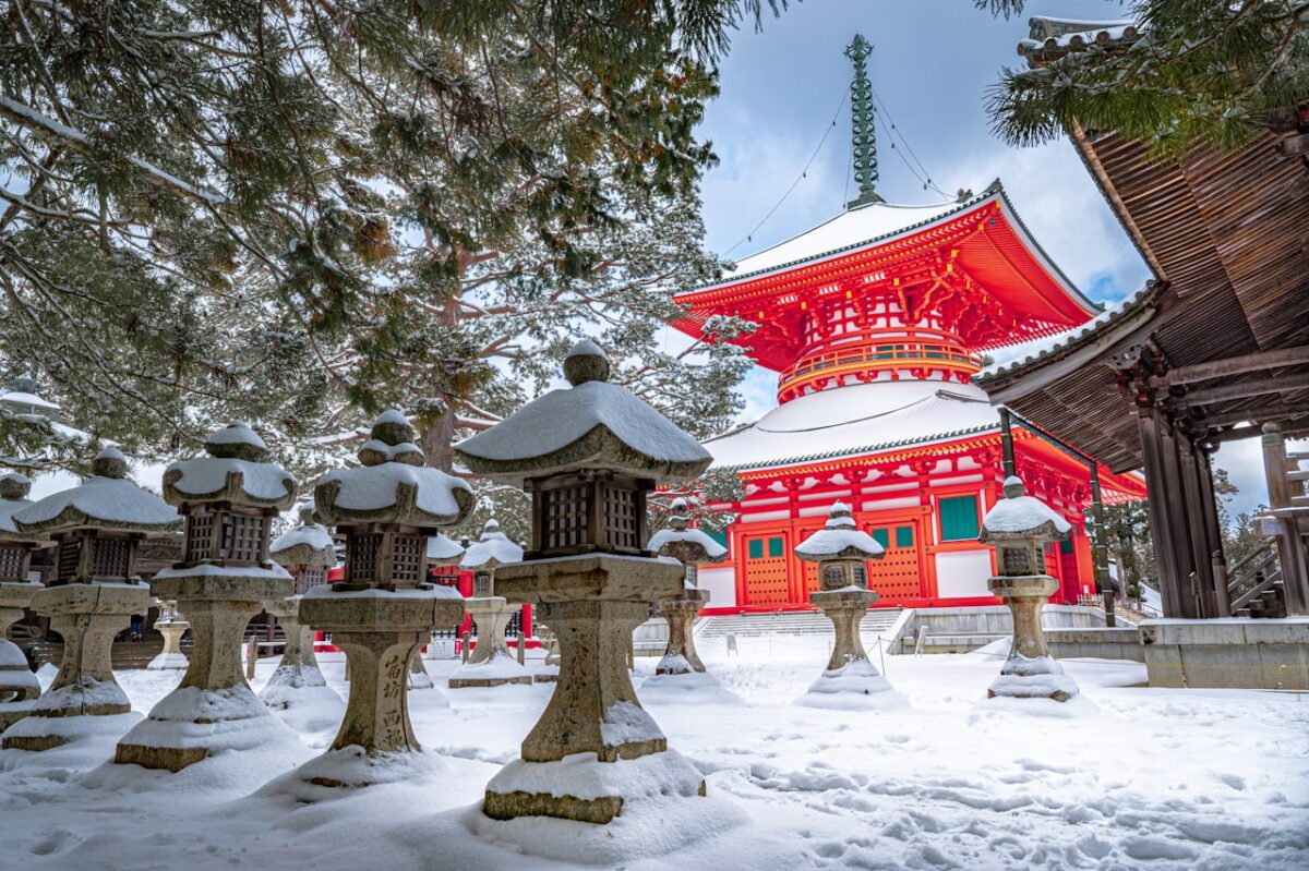 Best Time to Visit Japan: A Season-by-Season Guide for UK Travellers A red and white temple surrounded by snow-covered trees in Japan