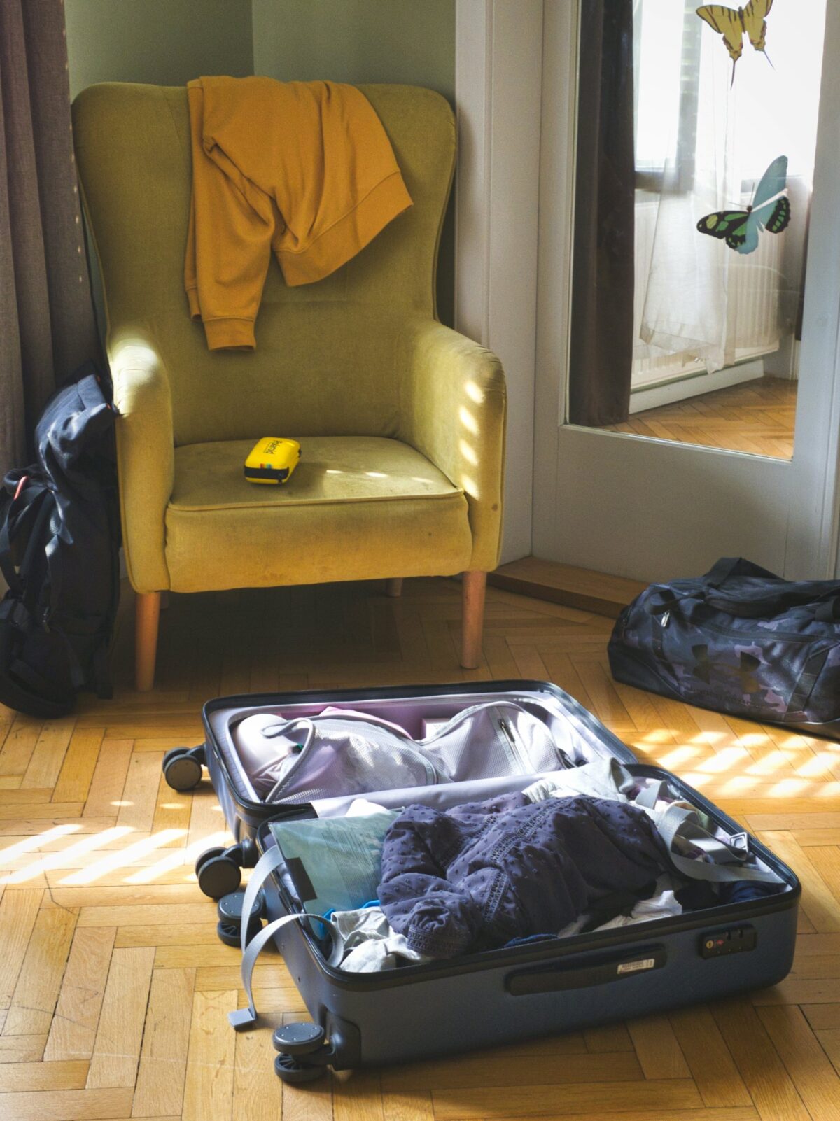 What to Pack for Japan: A UK Traveller's Seasonal Checklist An open suitcase with clothes laid out in a hotel room