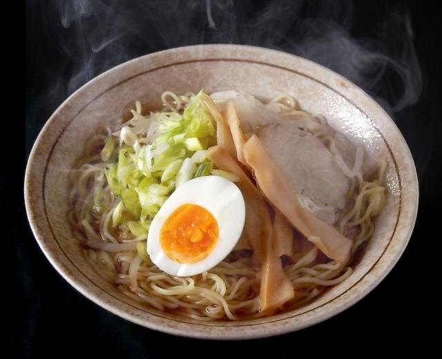 How to Enjoy a Rainy Day in Japan: Ideas for Travellers A steaming bowl of ramen topped with a soft-boiled egg