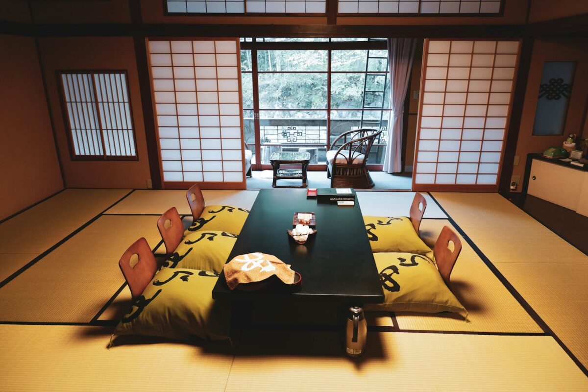 Staying in a Ryokan: What to Expect, from Check-in to Breakfast A dark wooden dining table set in a quiet Japanese room