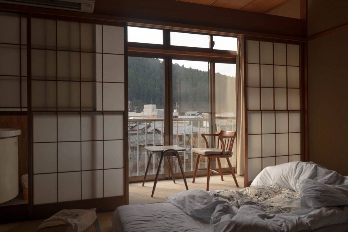 Staying in a Ryokan: What to Expect, from Check-in to Breakfast Bedding laid out on the floor of a Japanese room beside a window