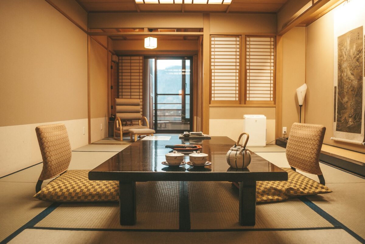 Staying in a Ryokan: What to Expect, from Check-in to Breakfast A low wooden table beside a window in a tatami room