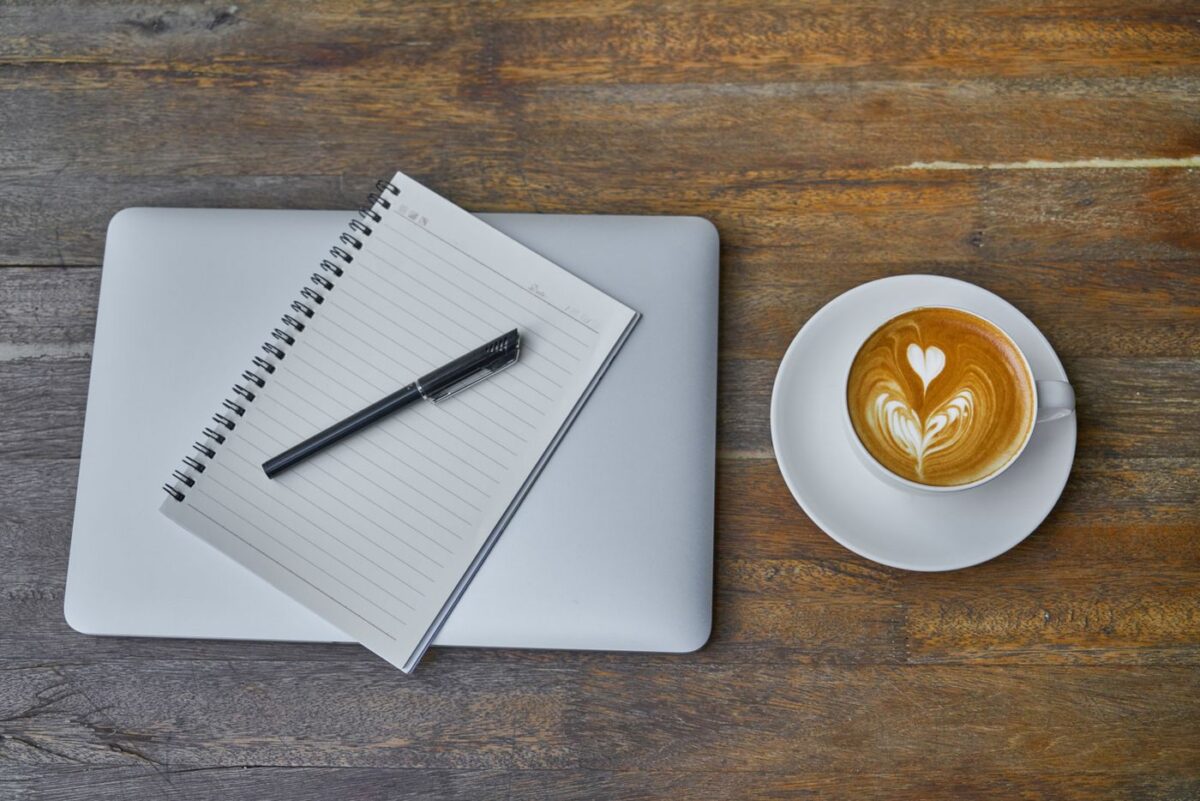 Private Japanese Lessons in London: Online Classes, with In-Person Café Sessions Available Coffee cup, notebook, pen and laptop on a wooden table