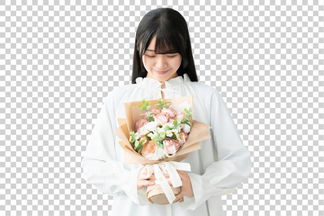 “Sumimasen” in Japan: The One Japanese Word Every Traveller Should Know A woman looking down at a bouquet of flowers she is holding, with a gentle smile
